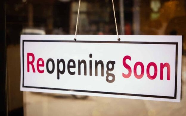 reopening soon signage board in front of businesses or restaurant door after covid 19 or coronavirus outbreak concept 183223707 1
