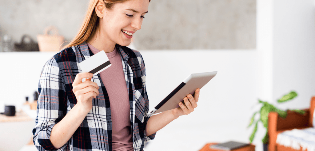 medium shot woman holding her credit card looking tablet 1