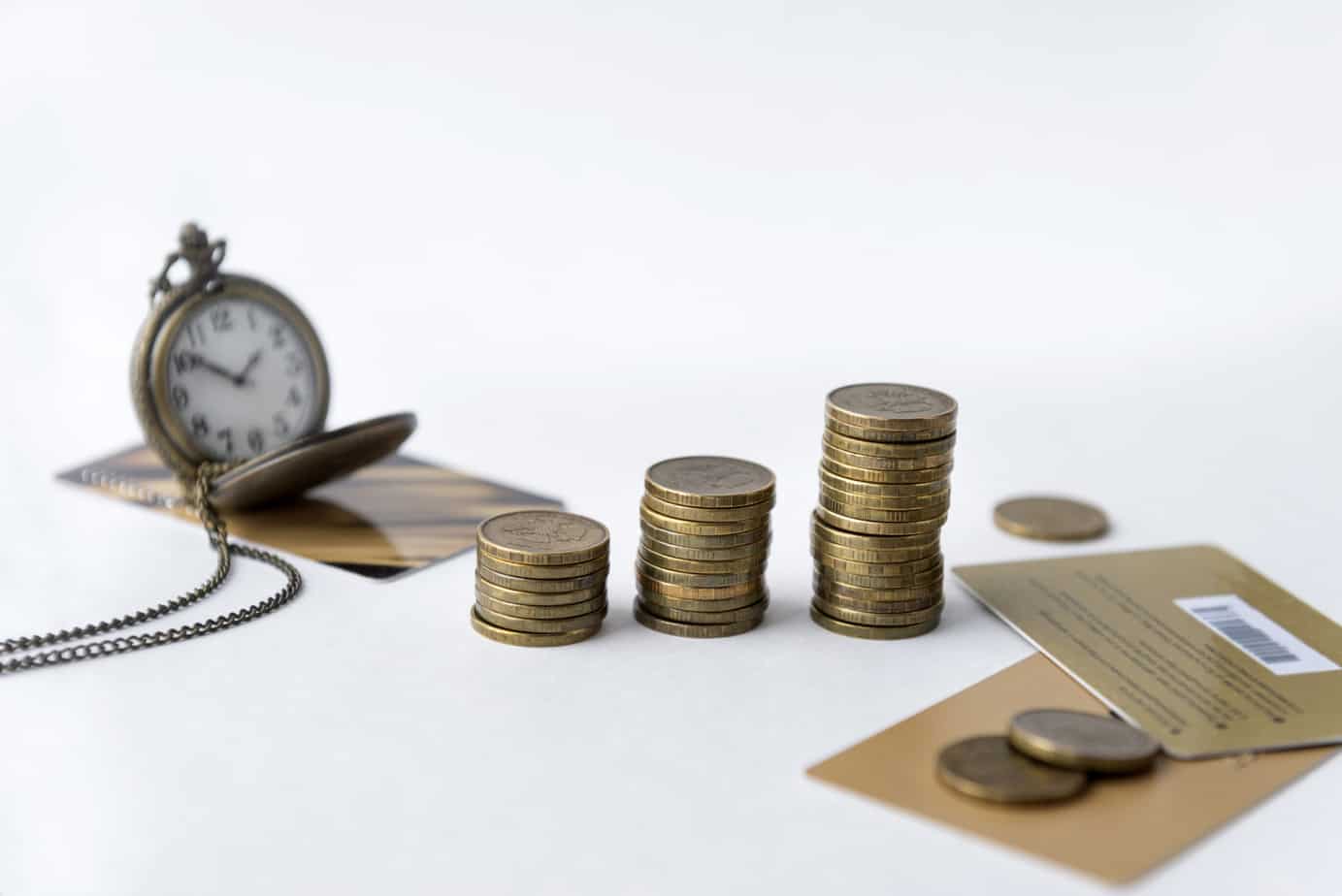 coins pocket watch on chain multiple bank cards on white background time money 137490281