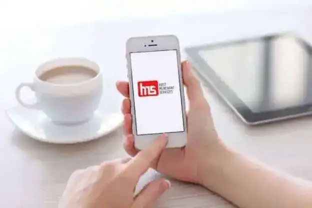 female hands holding white iphone 5s with app paypal on the screen in the office 41811441 1