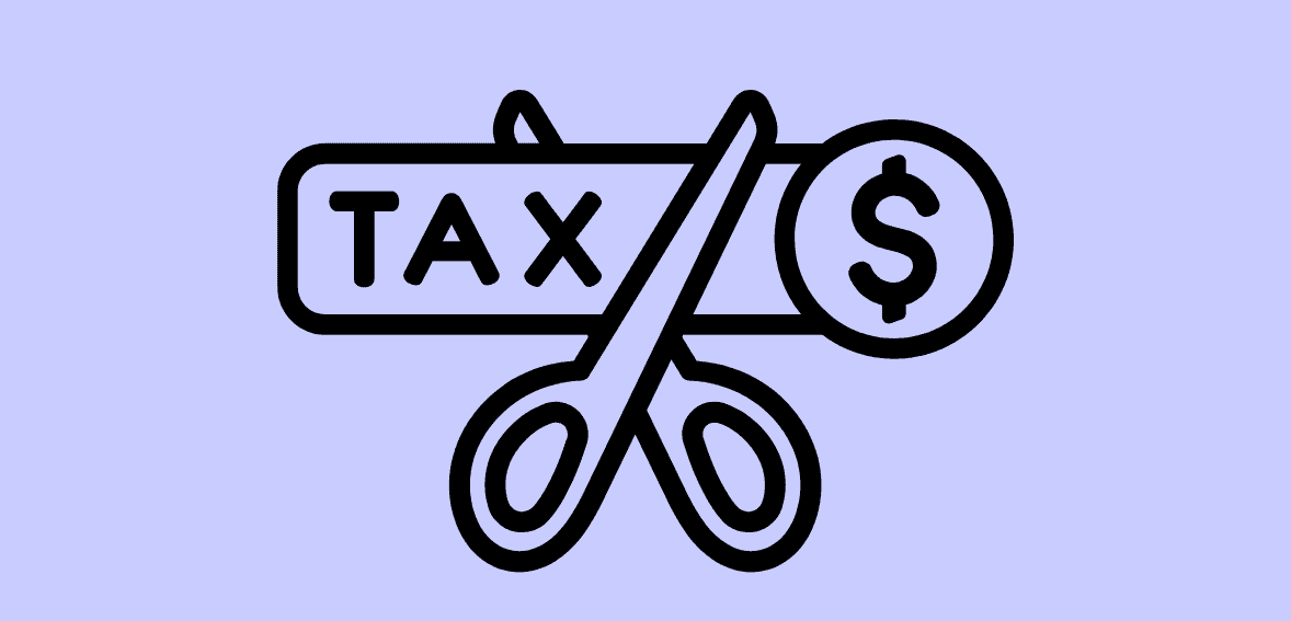 Tax scissors cutting through a dollar sign and tax label, representing tax savings and financial management.