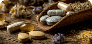 Supplements and vitamins on a rustic wooden surface for health and wellness.