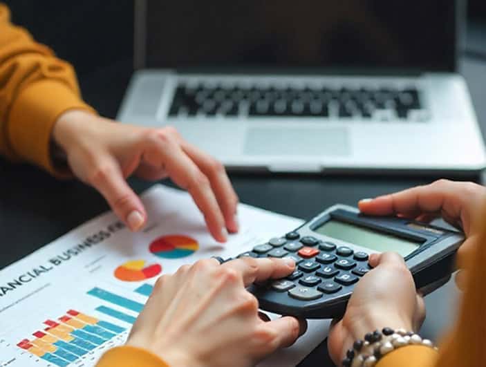 Financial business analysis with calculator and financial charts, accounting, data analysis, financial services, business finance, Host Merchant Services.