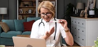 Elderly healthcare professional using a tablet in a cozy home setting.