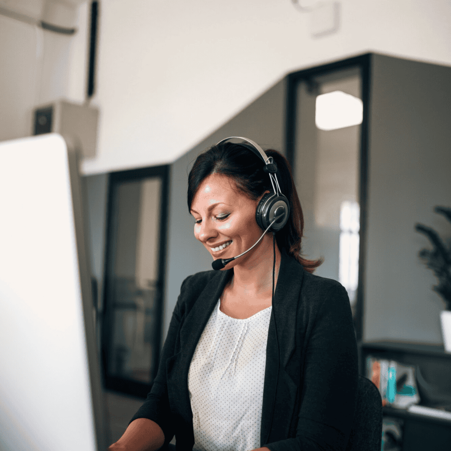 Efficient customer support representative wearing headset at work.
