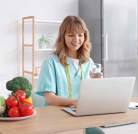 Modern woman using laptop for online data entry, digital payment, or e-commerce at home.