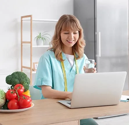 Modern woman using laptop for online data entry, digital payment, or e-commerce at home.
