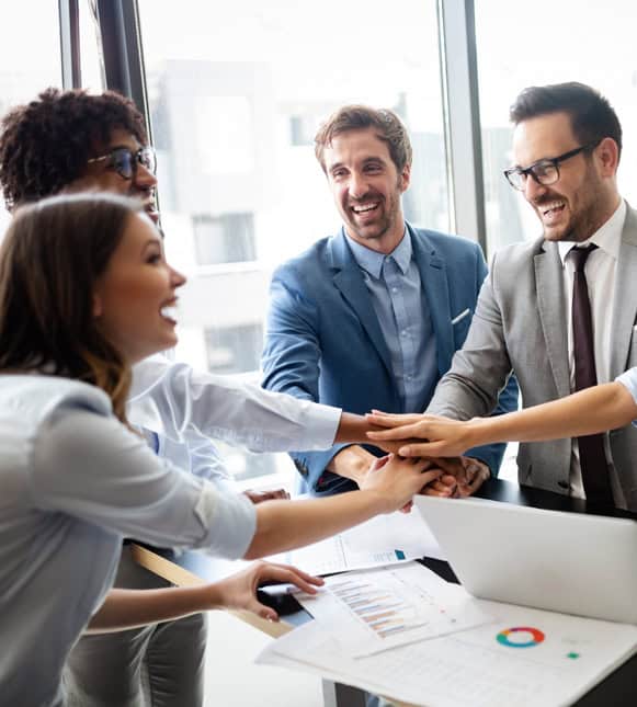 Friendly business team celebrating partnership at modern office.