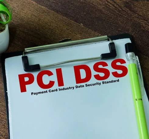 PCI DSS compliance on a clipboard, emphasizing payment security standards.