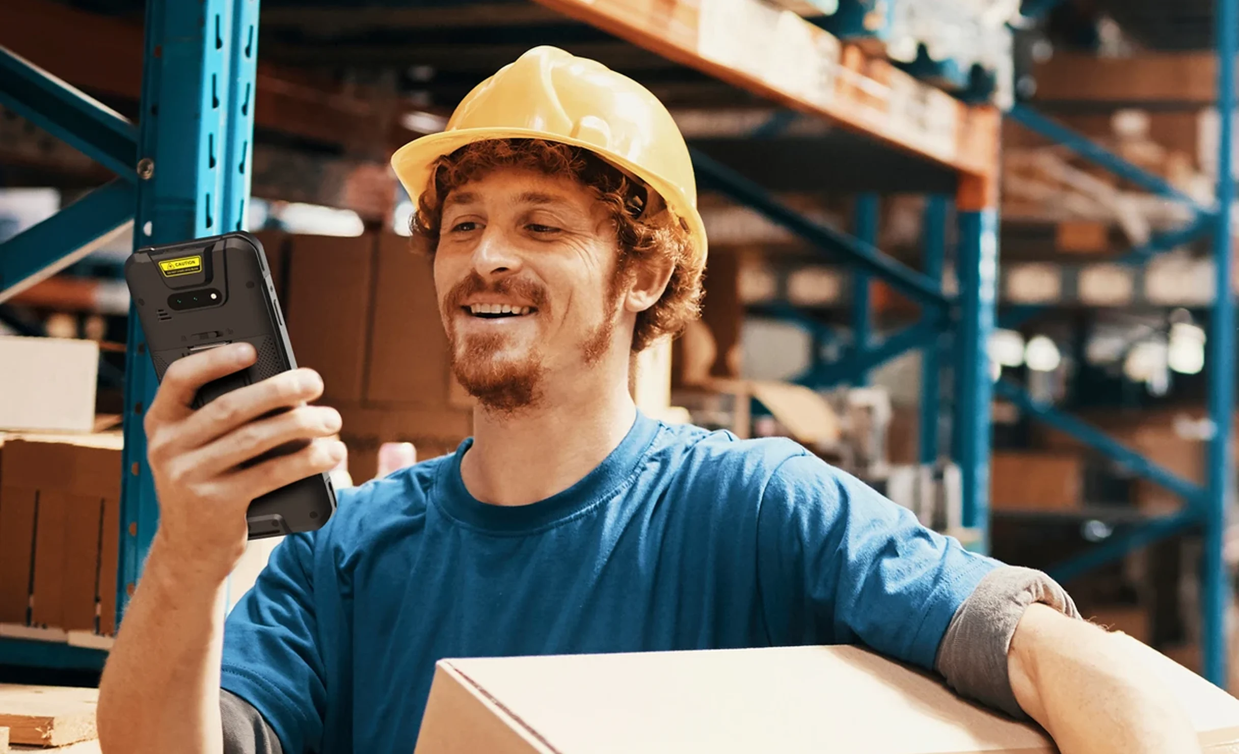 Warehouse employee using a PAX A6650 handheld SmartPOS terminal for efficient mobile business operations