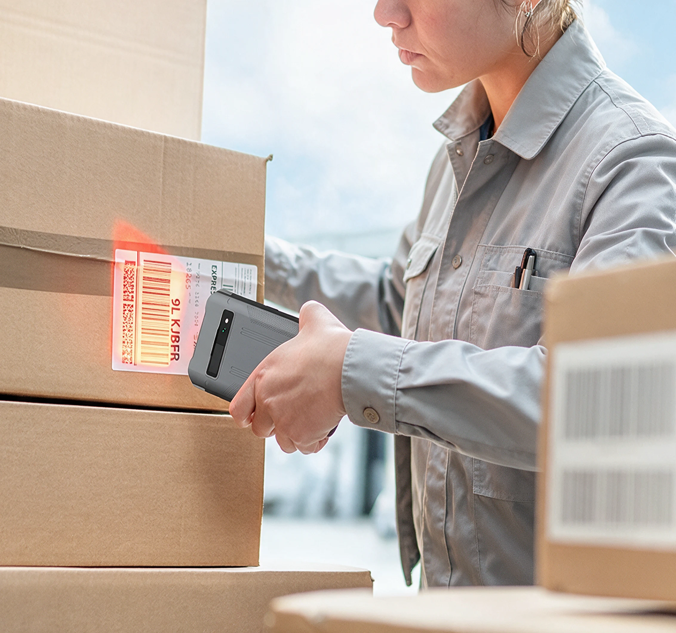 Worker using the PAX A6630 mobile POS terminal to scan a package barcode for fast in-person payment and order workflows