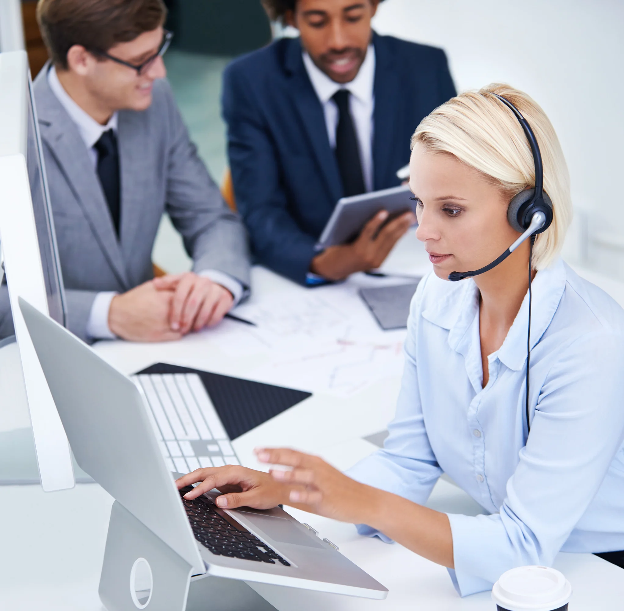 Customer support representative wearing a headset assisting businesses with Valor VL300 payment terminal questions