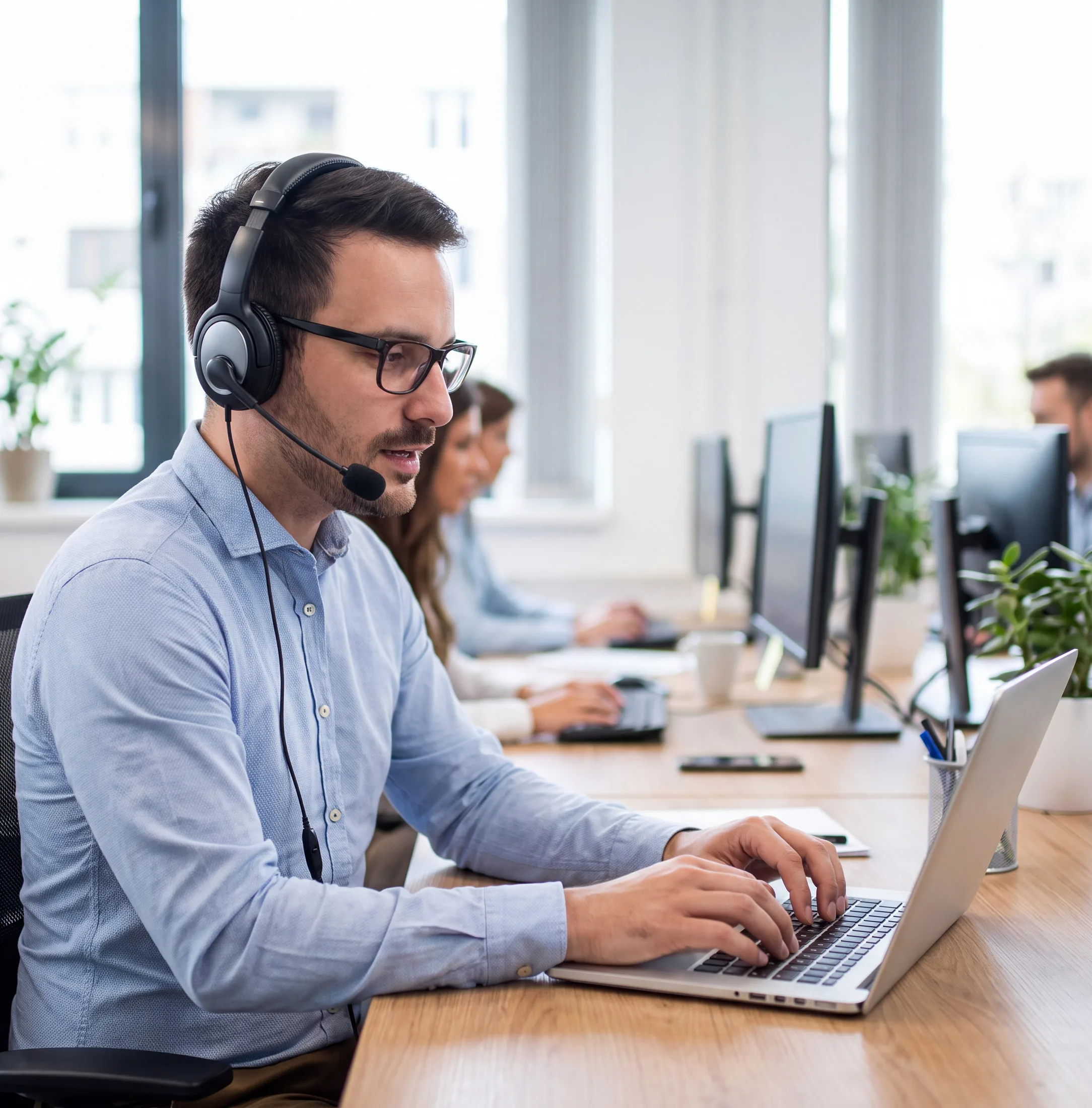 Customer support representative wearing a headset assisting with Valor VL550 payment terminal questions