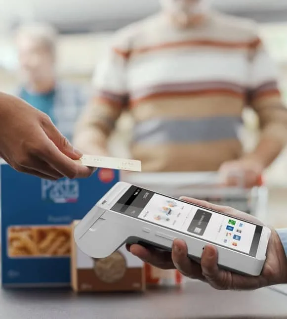 Contactless payment transaction using a modern POS terminal and credit card.