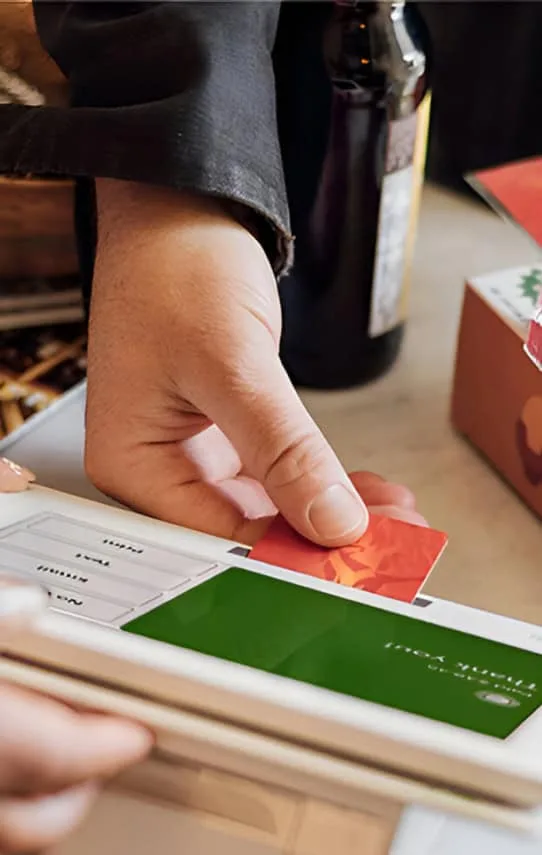 Contactless credit card payment at a restaurant or café.