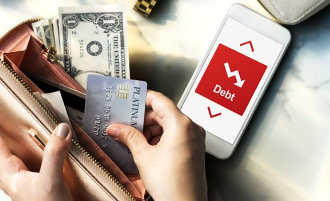 debt ridk difficulty downfall concept Debt management financial crisis on smartphone screen with cash and credit cards in purse.