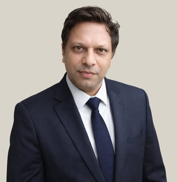 Business professional in formal suit representing Host Merchant Services, offering payment processing solutions for businesses.