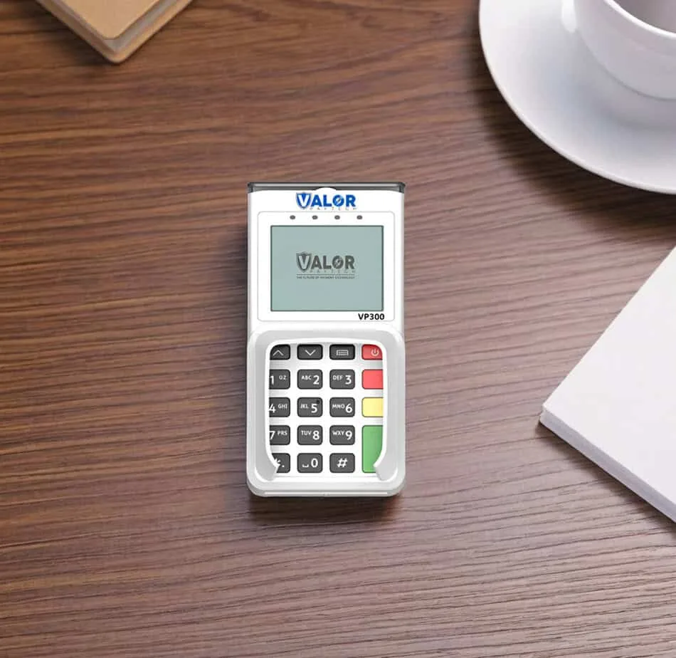 Chip card payment terminal on wooden desk promoting Host Merchant Services.