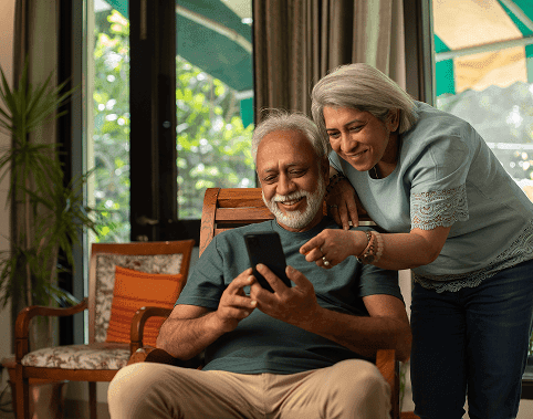 Elderly couple enjoying a mobile payment, representing seamless merchant payment solutions.