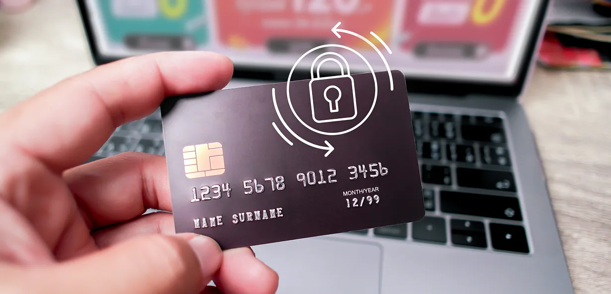 Secure card payment using a blue chip on a laptop keyboard.