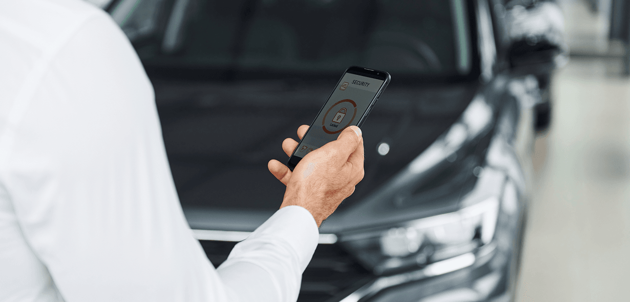 Mobile payment app on smartphone at car dealership, digital payment solution.