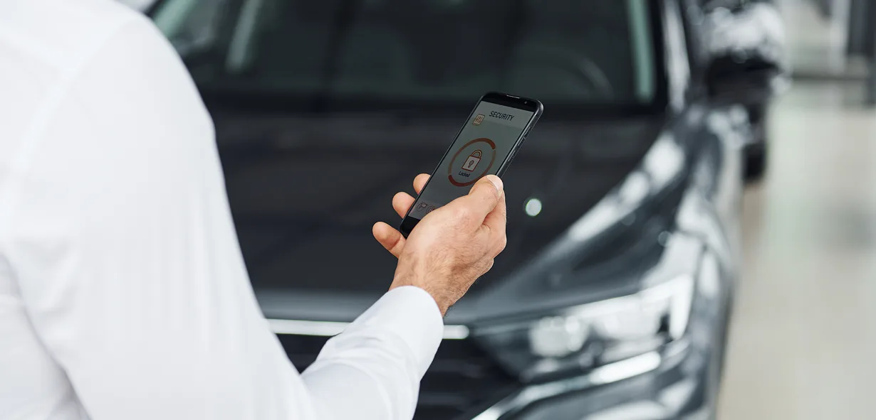 Mobile payment app on smartphone at car dealership, digital payment solution.