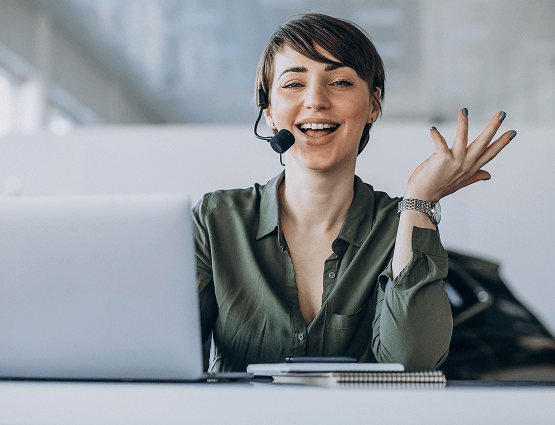 Customer service representative with headset at laptop, providing payment processing support for Host Merchant Services.