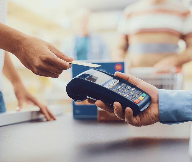 Contactless credit card payment transaction outdoors at sunset.