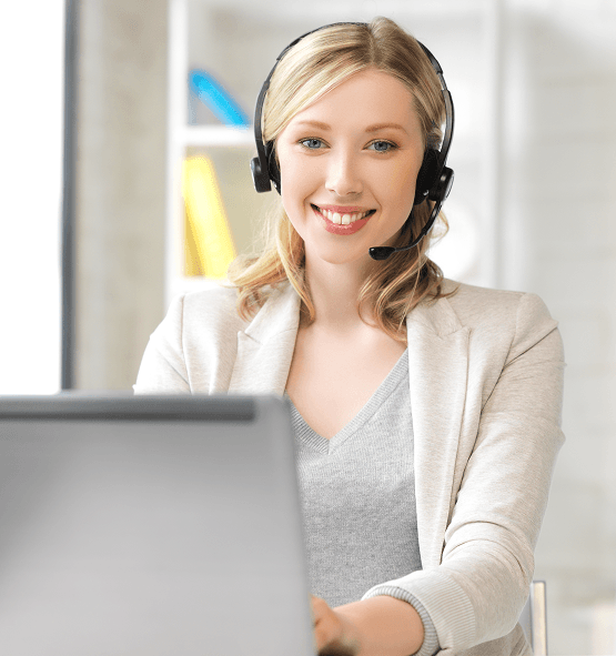 Call center agent with headset working at computer for Customer Service support.