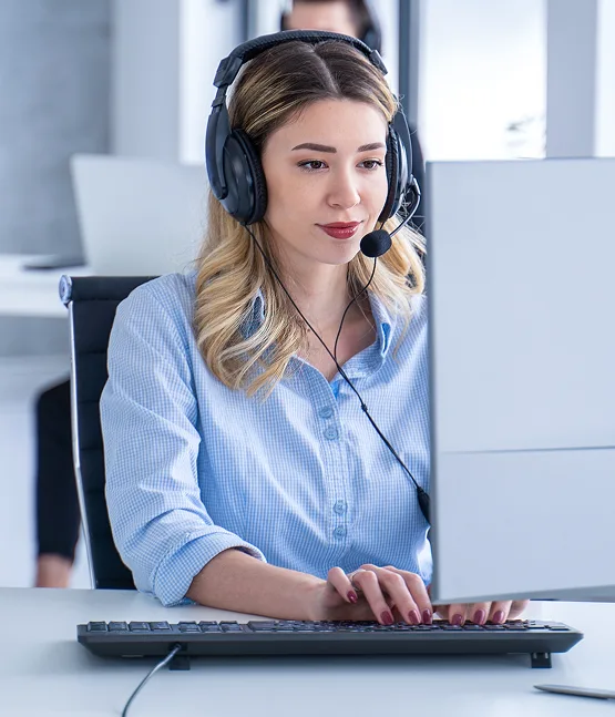 Customer service representative with headset at laptop, providing payment processing support for Host Merchant Services.