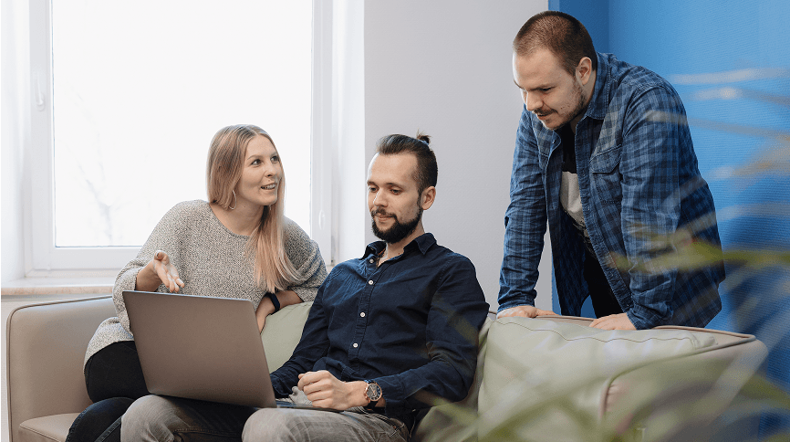 Business meeting with laptop and financial discussion, modern office environment.