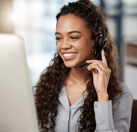 Responsive customer support representative with headset providing payment solutions at a call center.