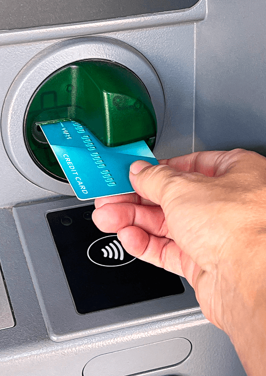 hand putting credit card atm