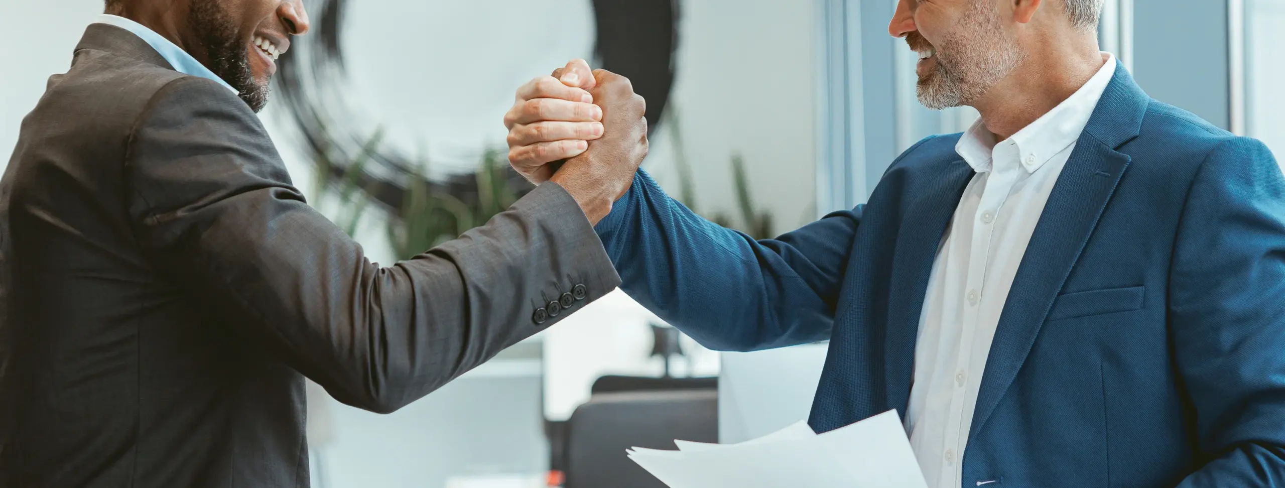 Business professionals strengthening a merchant partnership through business funding and Merchant Cash Advance solutions