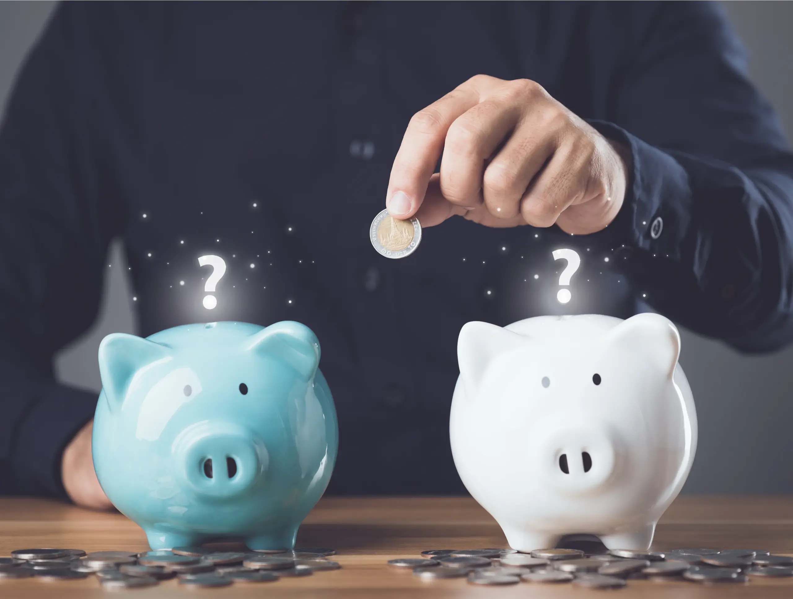 Person placing a coin between two piggy banks to compare savings and certificate of deposit earnings