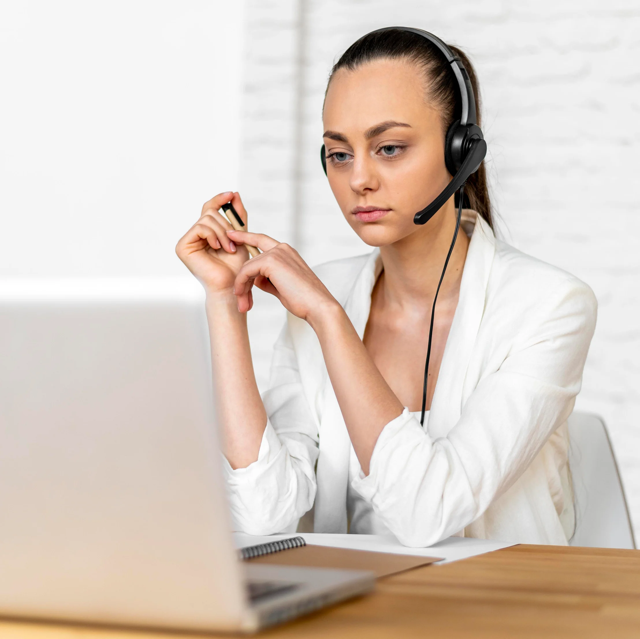 Customer support representative wearing a headset assisting businesses with ACH and eCheck payment questions