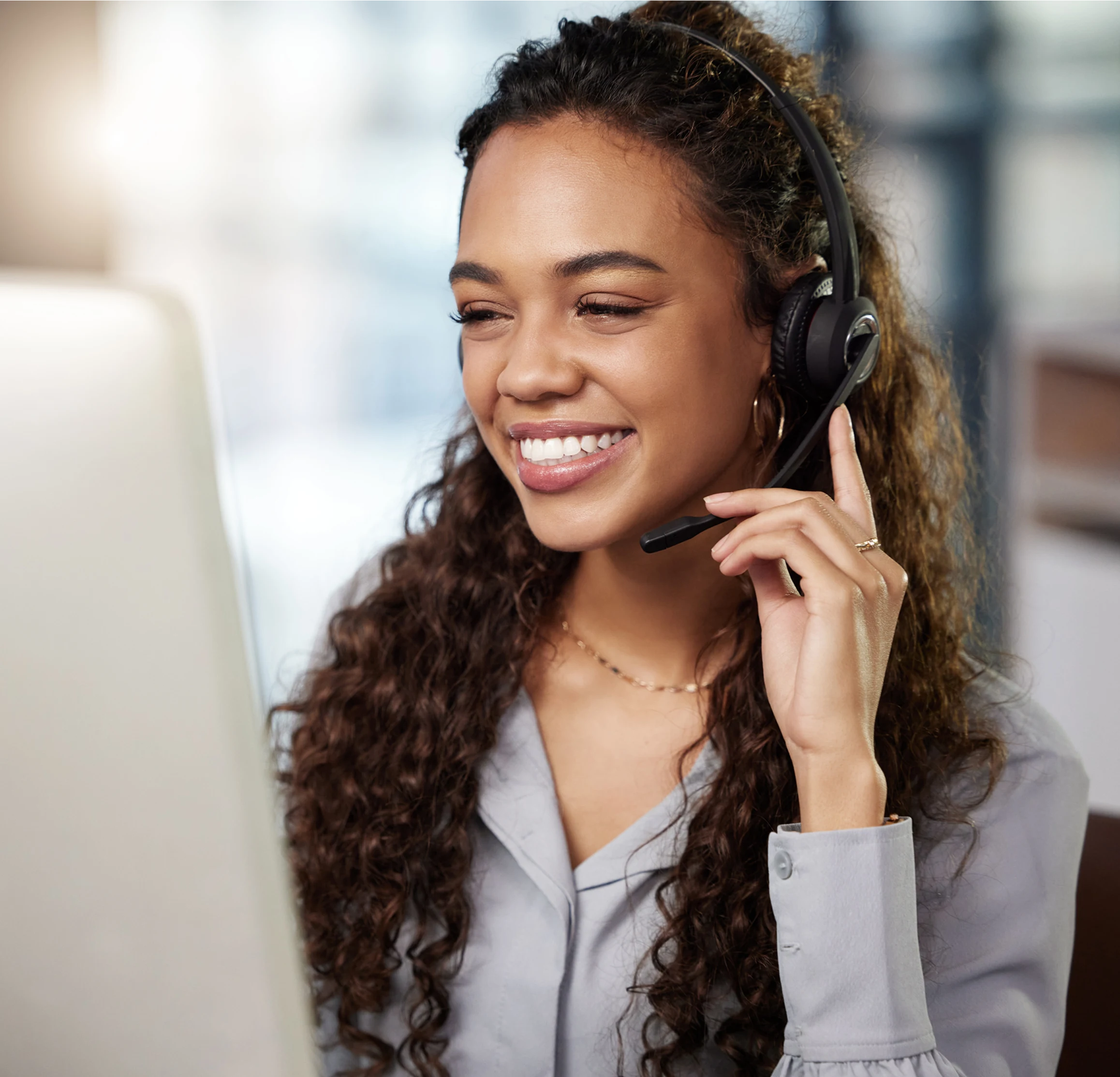 Responsive customer support representative with headset providing payment solutions at a call center.