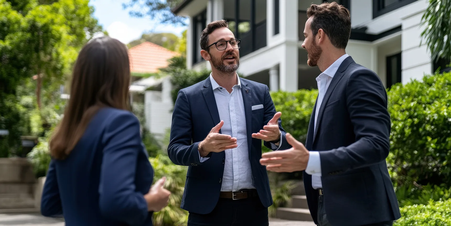 Real estate professionals discussing property management solutions and payment services outside a residential property