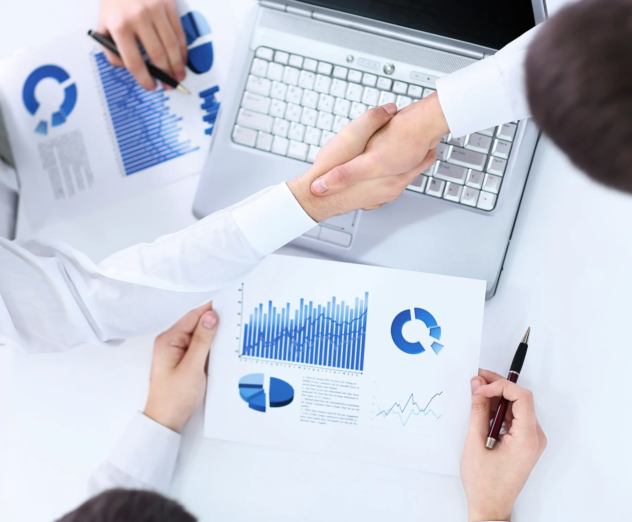 Business professionals reviewing payment analytics and financial reports while discussing integrated business systems