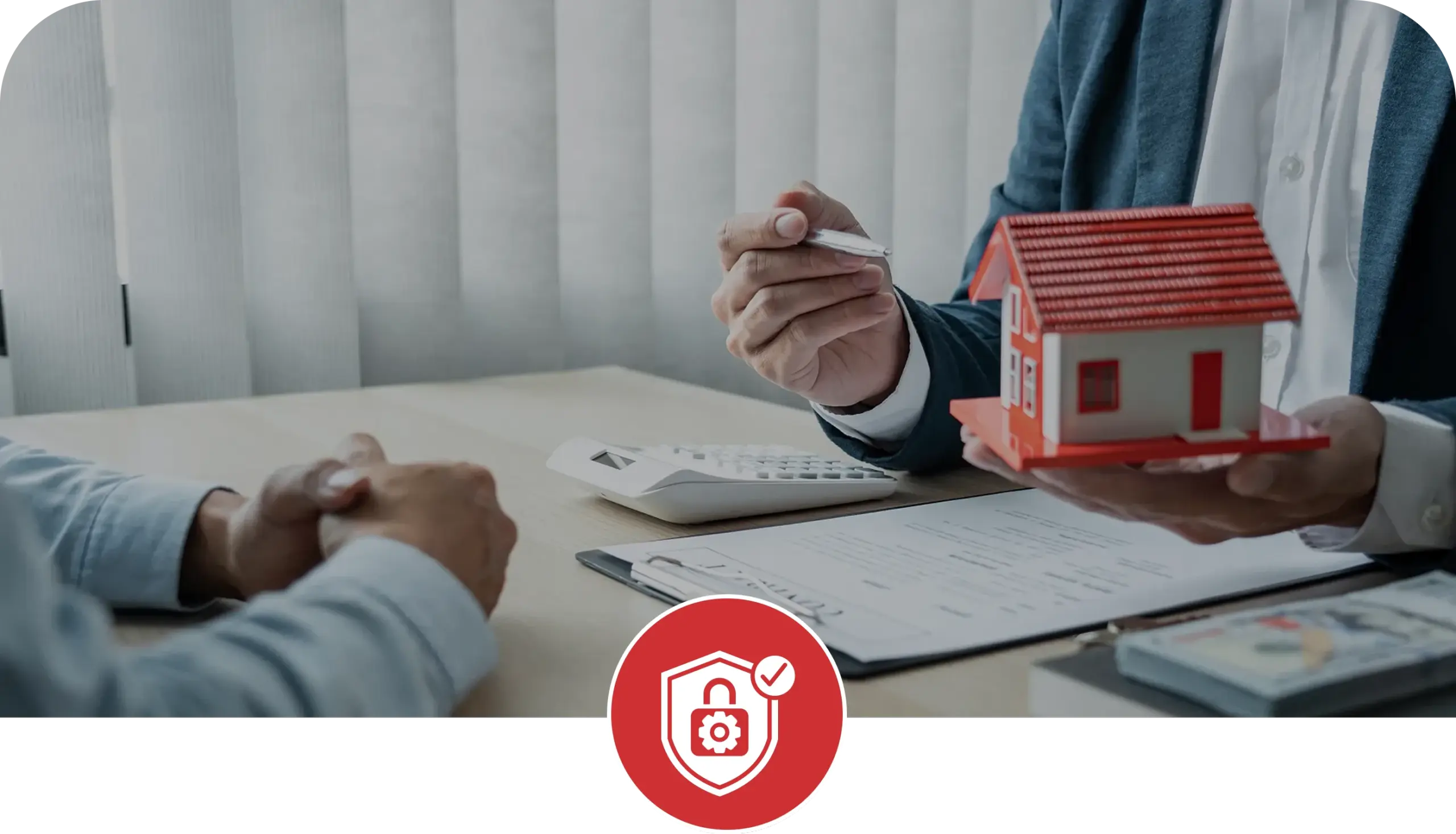 Real estate professional holding a model home during a property consultation with a security and compliance icon