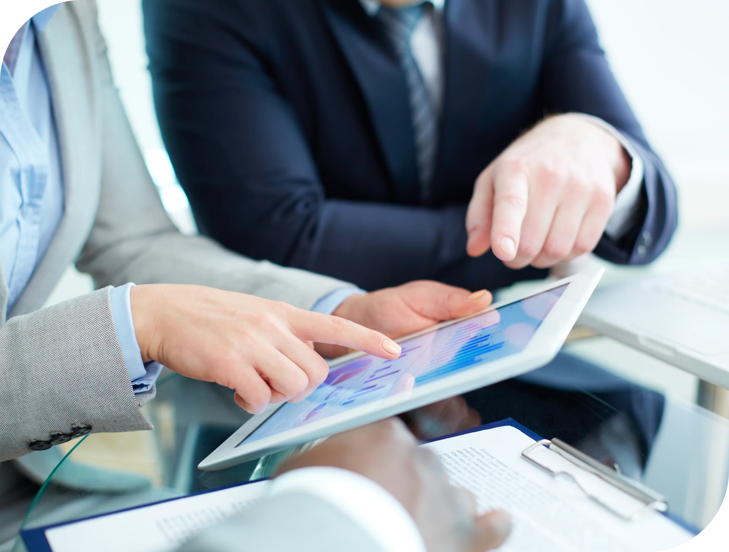 Business professionals reviewing financial charts on a tablet while discussing business funding and working capital options